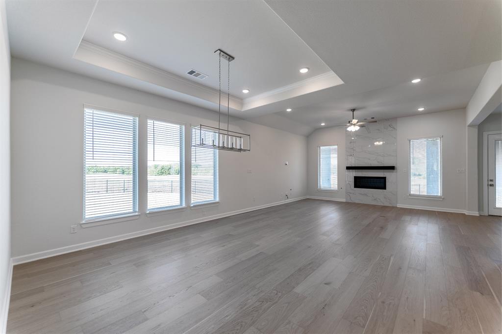 3908 Friendship Court Forney, TX 75126 - Photo 4 of 29 an empty room with wooden floor and windows