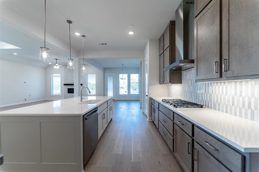 3908 Friendship Court Forney, TX 75126 - Photo 10 of 29 a kitchen with stainless steel appliances granite countertop a sink and stove