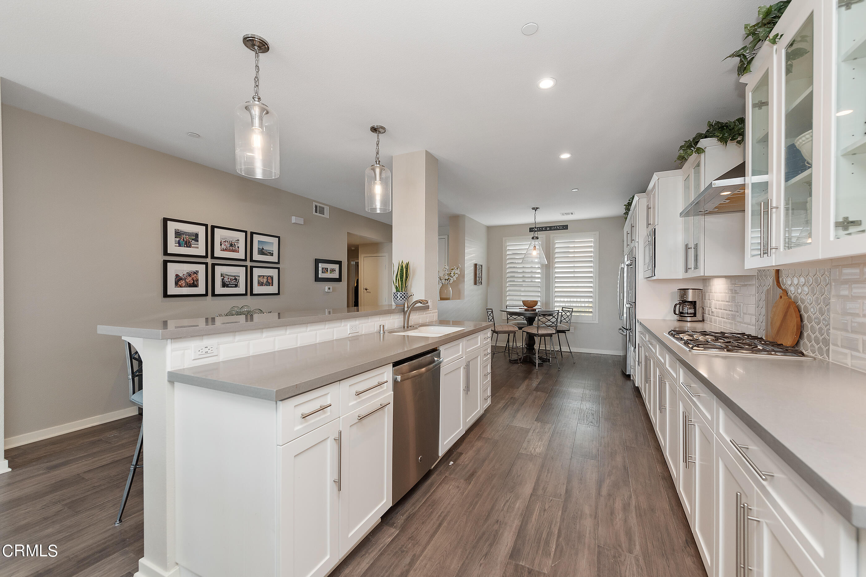 4048 Tradewinds Drive Oxnard, CA 93035 - Photo 14 of 53 a large kitchen with kitchen island a stove a sink a center island and wooden floor