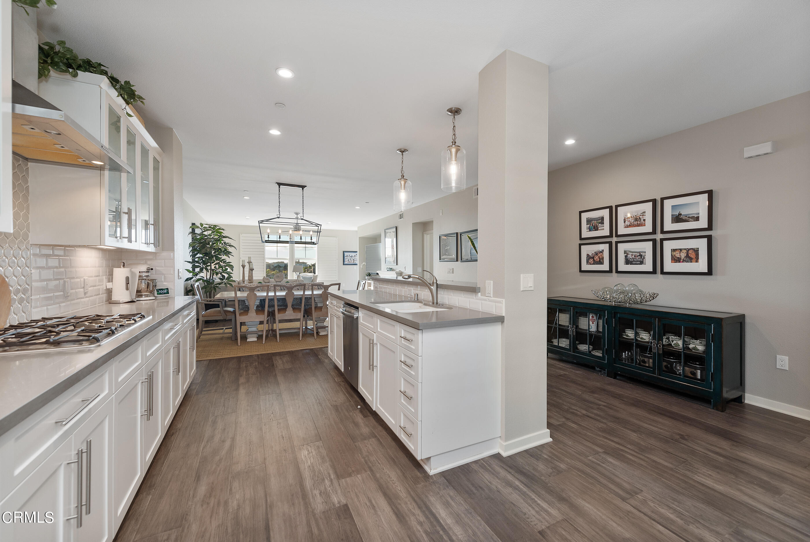 4048 Tradewinds Drive Oxnard, CA 93035 - Photo 15 of 53 a kitchen with a refrigerator a stove top oven a sink and wooden floor