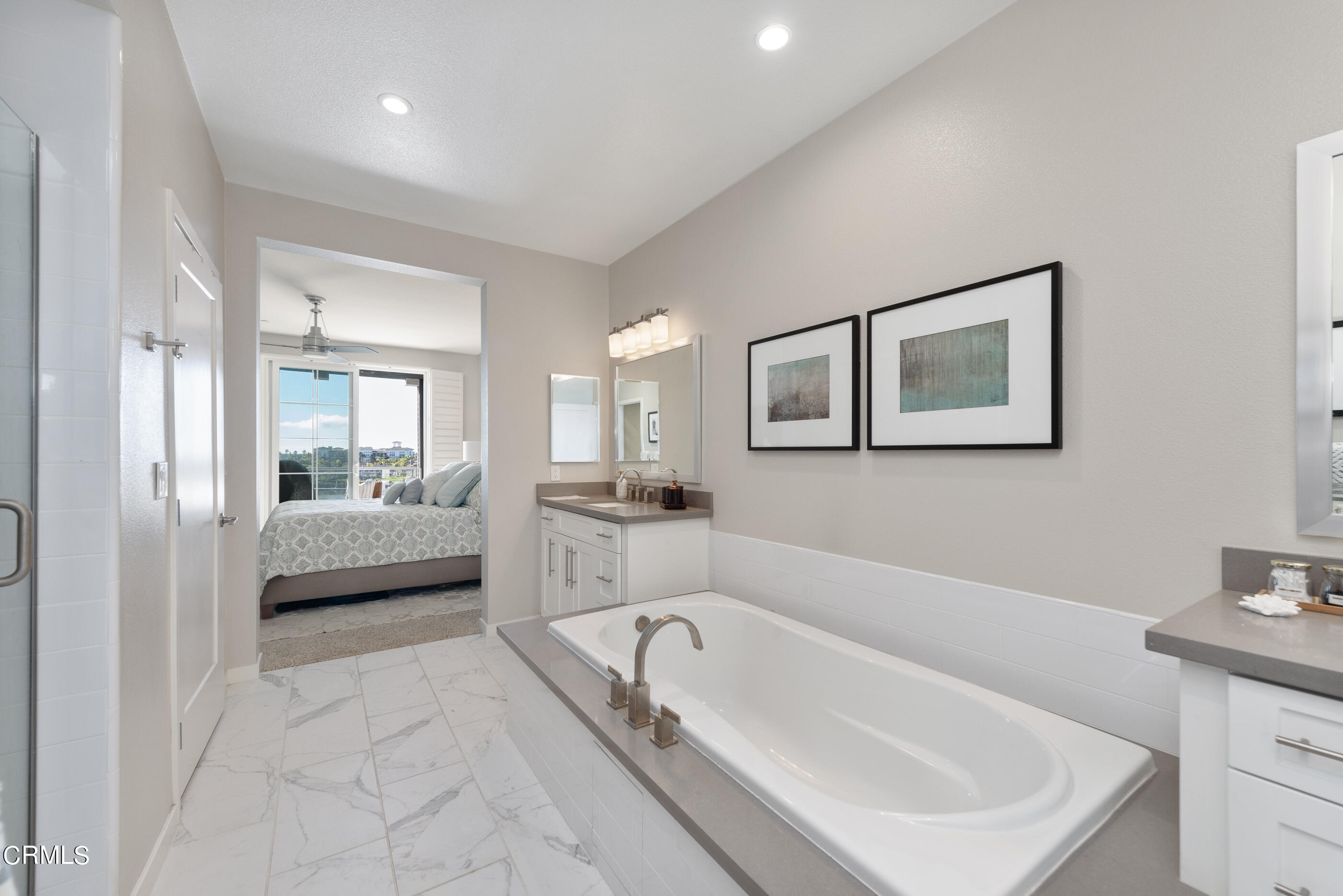 4048 Tradewinds Drive Oxnard, CA 93035 - Photo 22 of 53 a bathroom with a tub a sink and a mirror