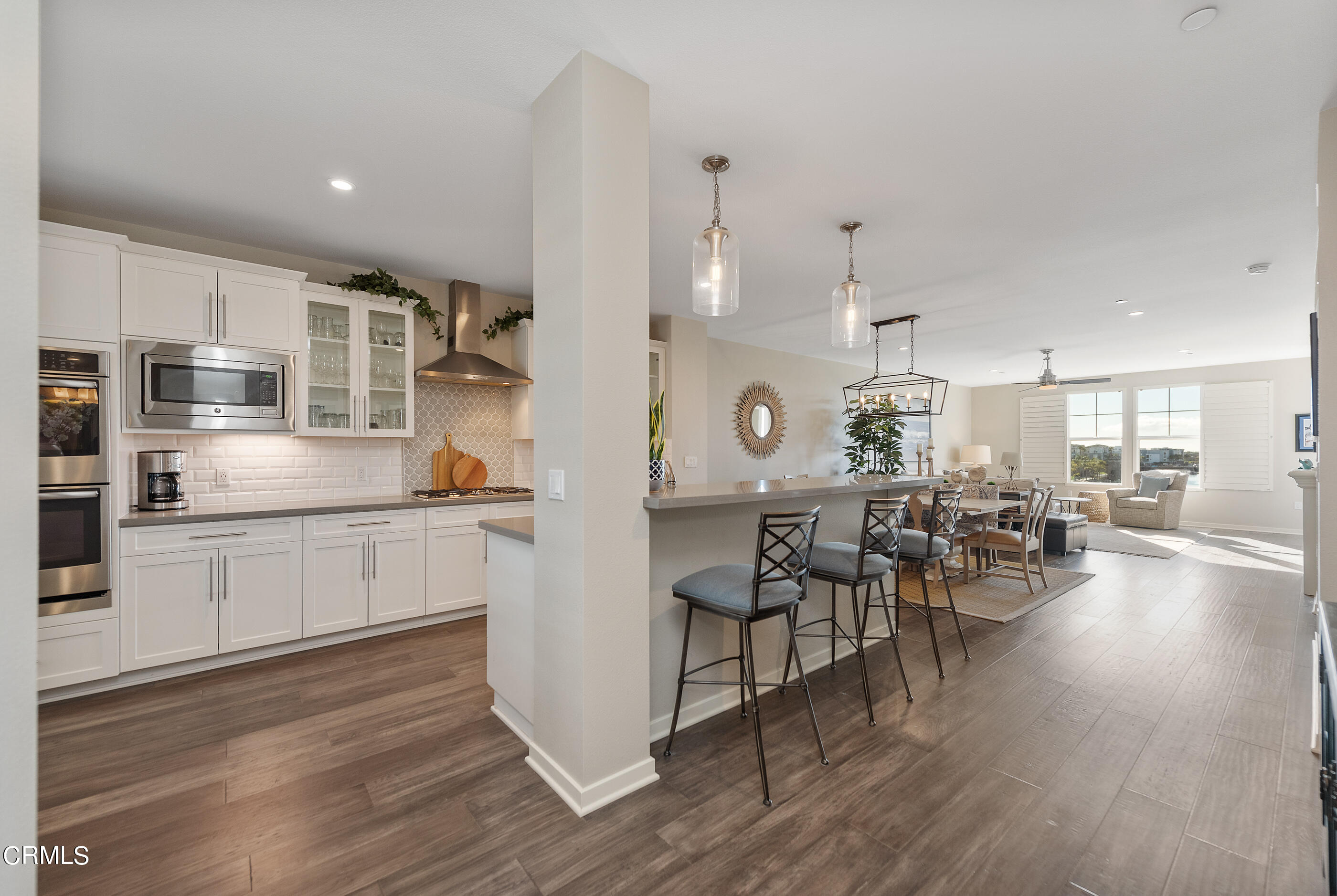 4048 Tradewinds Drive Oxnard, CA 93035 - Photo 6 of 53 a large white kitchen with lots of counter top space and stainless steel appliances