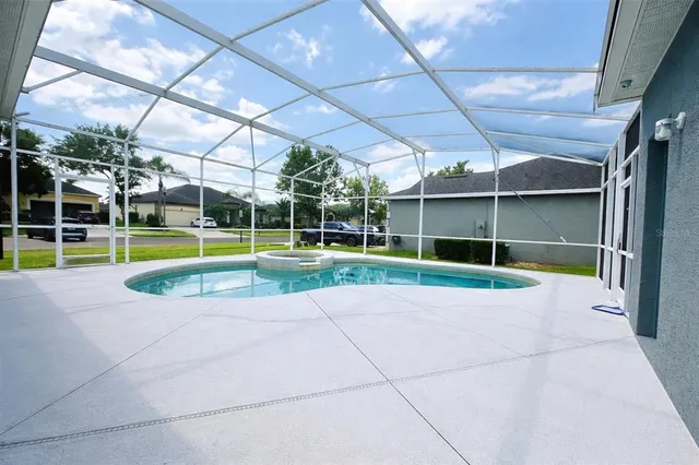 a view of a swimming pool with a patio