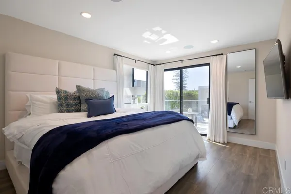 a bedroom with a large bed and a large window