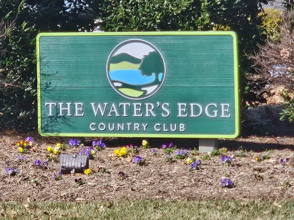 a sign that is on the side of the wooden fence