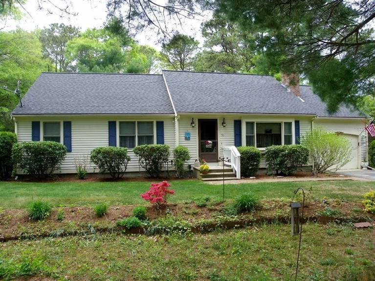 a front view of a house with a yard and porch