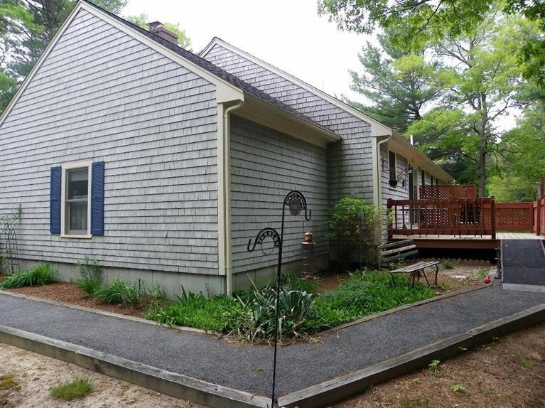56 Shields Road Mashpee, MA 02649 - Photo 4 of 17 a view of a house with a yard and a garden