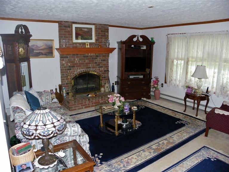 56 Shields Road Mashpee, MA 02649 - Photo 6 of 17 a living room with furniture and a fireplace