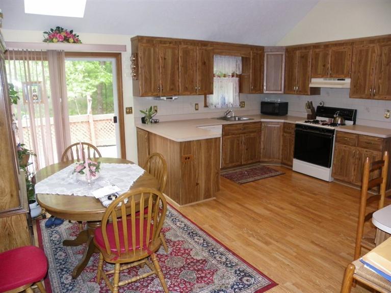 56 Shields Road Mashpee, MA 02649 - Photo 7 of 17 a kitchen with a sink a stove a table and chairs