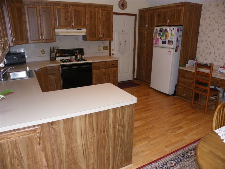 56 Shields Road Mashpee, MA 02649 - Photo 8 of 17 a kitchen with stainless steel appliances a stove a refrigerator and wooden cabinets