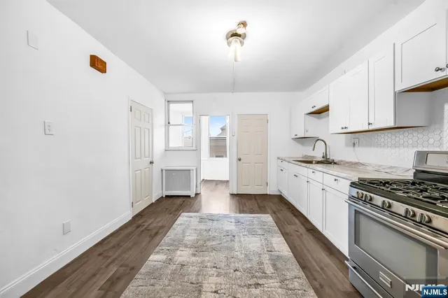 a kitchen with a refrigerator and a stove