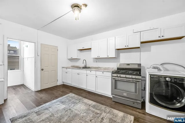 a kitchen with a stove top oven sink and cabinets