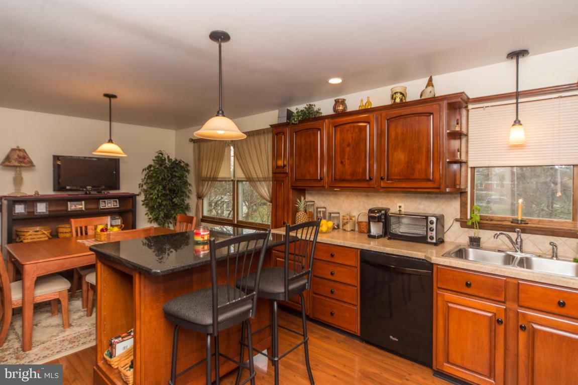 956 Spring Road Elizabethtown, PA 17022 - Photo 11 of 27 a kitchen with stainless steel appliances granite countertop a stove top oven a sink a counter and chairs