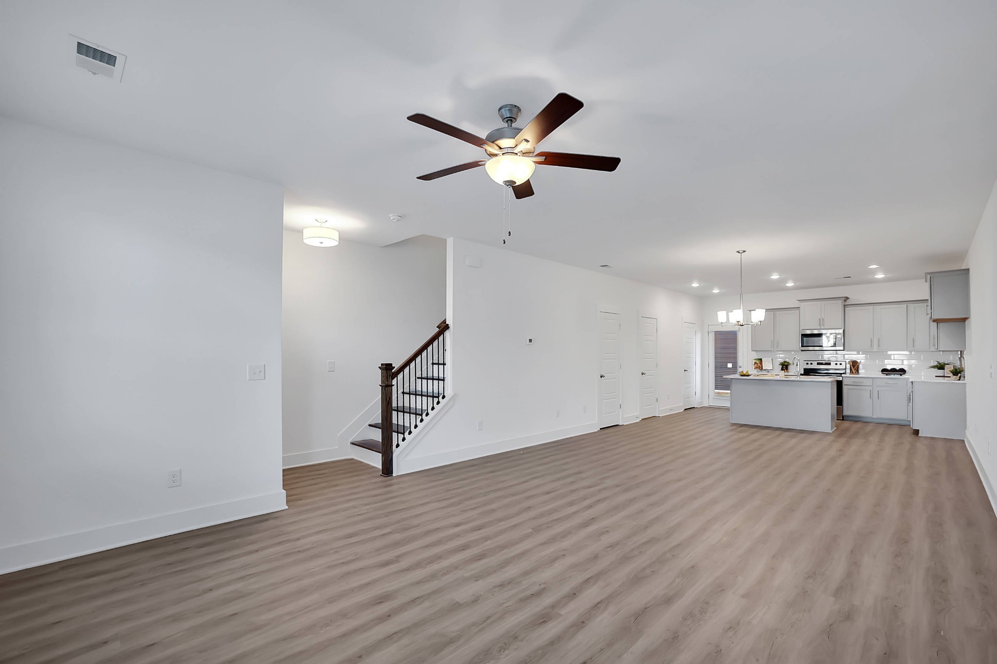 106 Floyd Junction Lebanon, TN 37087 - Photo 12 of 24 a view of a livingroom with wooden floor and a ceiling fan