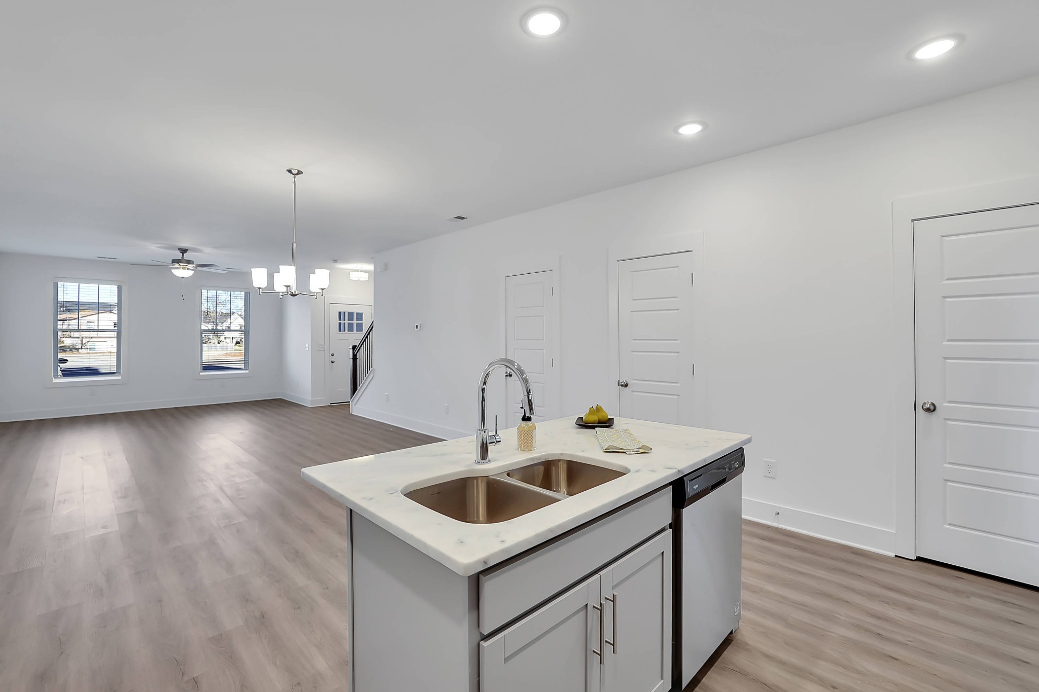 106 Floyd Junction Lebanon, TN 37087 - Photo 9 of 24 a kitchen that has a sink a microwave oven a stove and white cabinets with wooden floor
