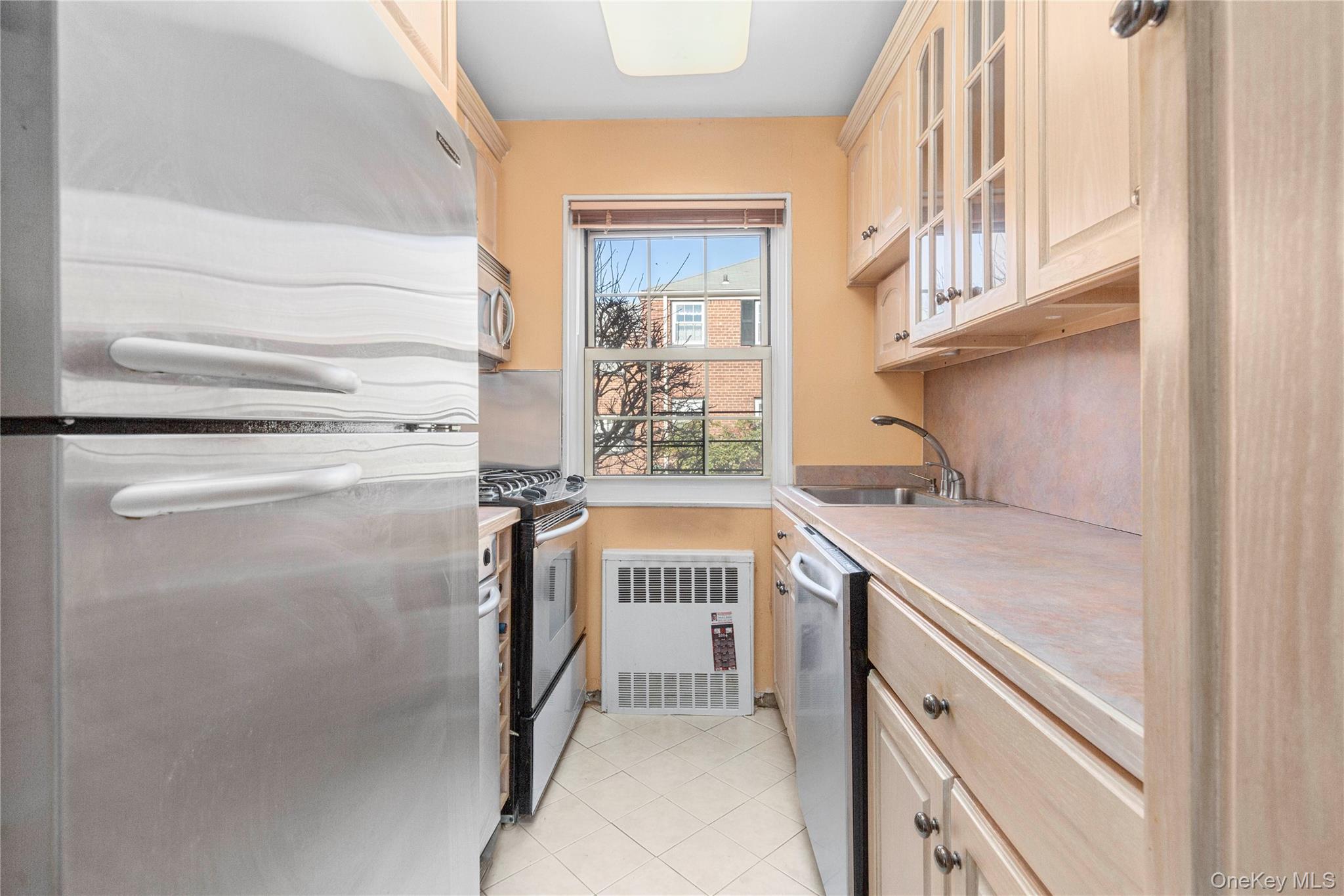 69-21 215th Street, Unit A Queens, NY 11364 - Photo 9 of 14 a kitchen with a stove and a refrigerator