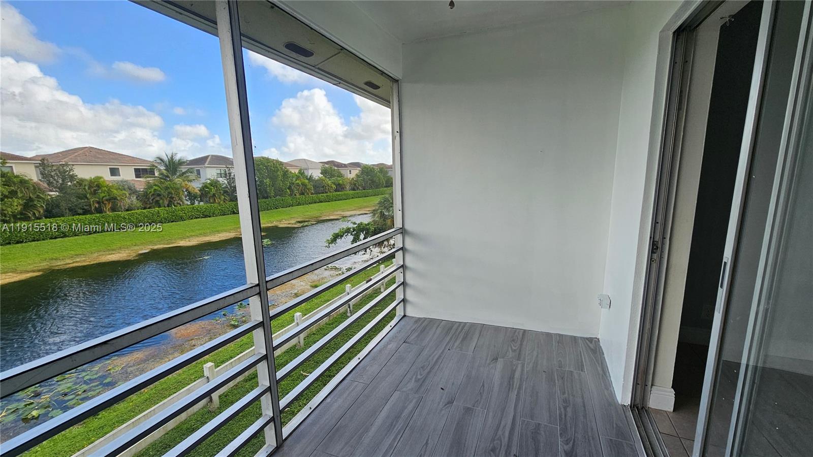 8901 Northwest 38th Drive, Unit 206 Coral Springs, FL 33065 - Photo 16 of 17 a view of balcony with floor to ceiling windows with wooden floor