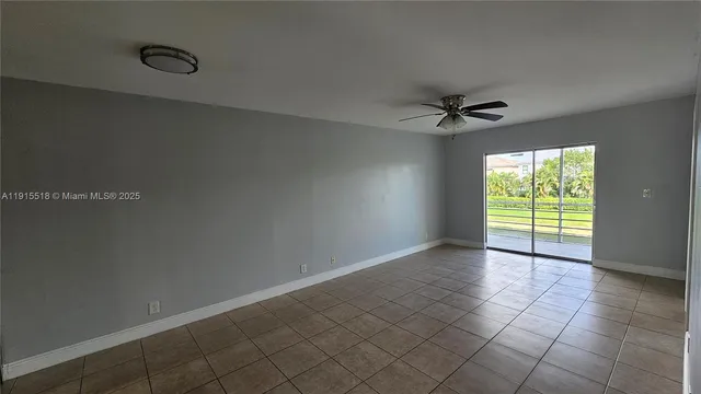 a view of a livingroom with a ceiling fan and window