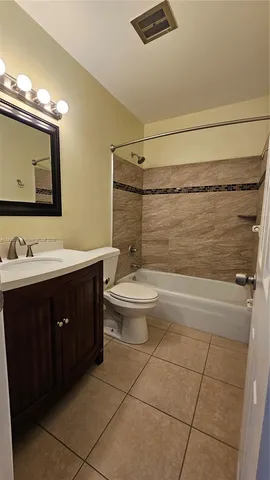 a bathroom with a sink vanity mirror and toilet