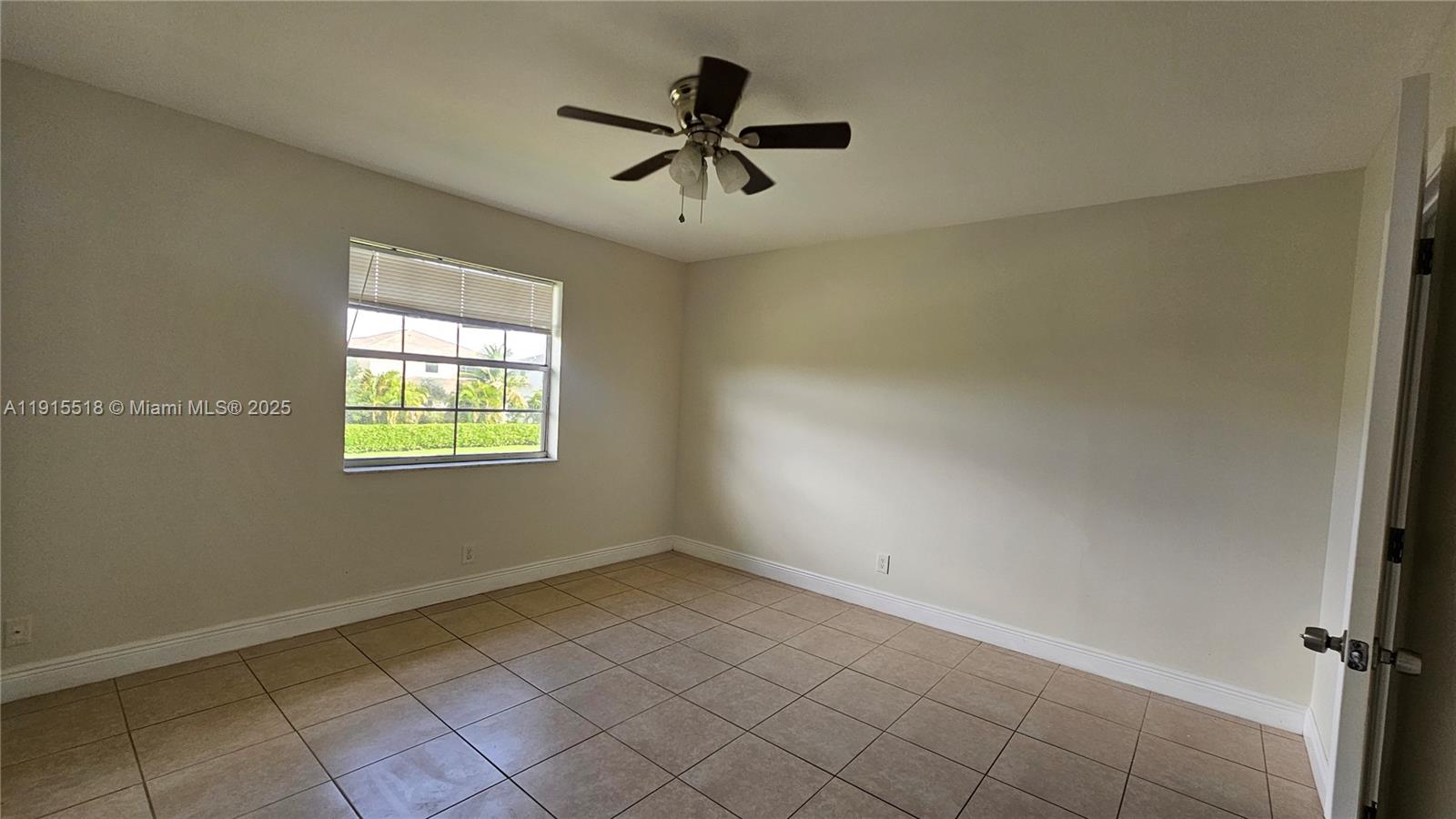 8901 Northwest 38th Drive, Unit 206 Coral Springs, FL 33065 - Photo 8 of 17 wooden floor in an empty room with a window