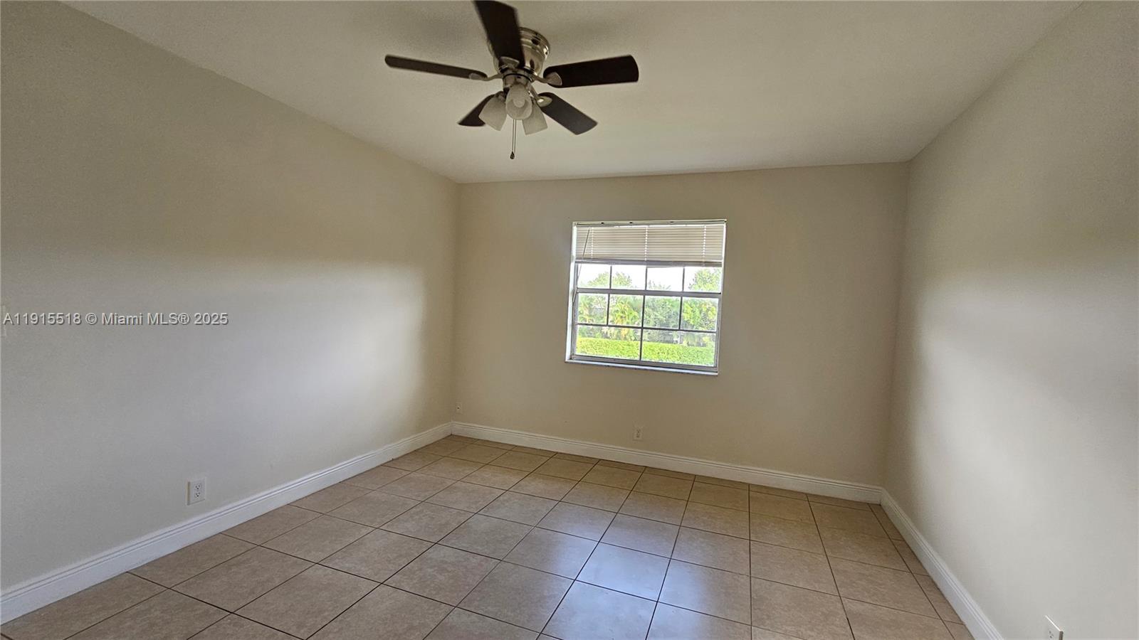 8901 Northwest 38th Drive, Unit 206 Coral Springs, FL 33065 - Photo 9 of 17 an empty room with a window and a fan