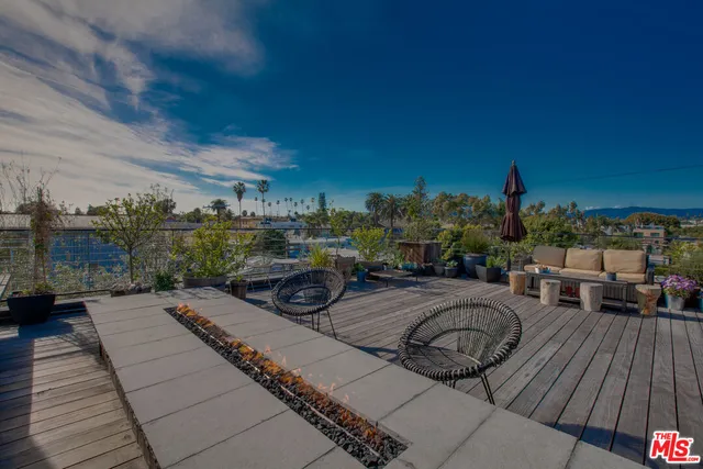 a view of a couches and dinning table and chairs in patio