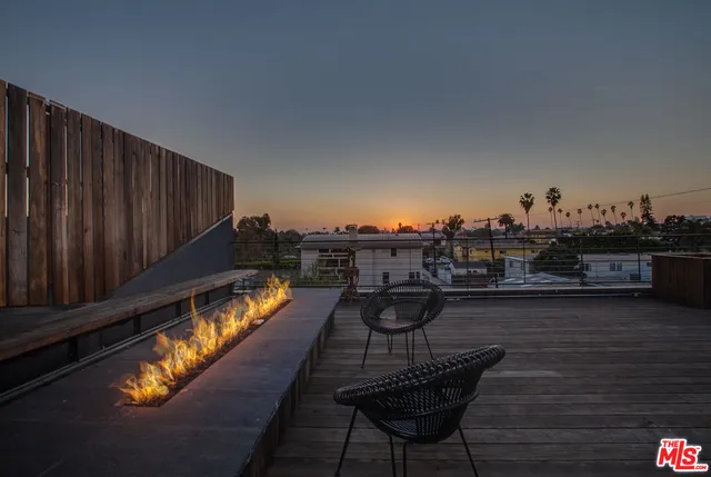a view of a balcony with chair and wooden floor