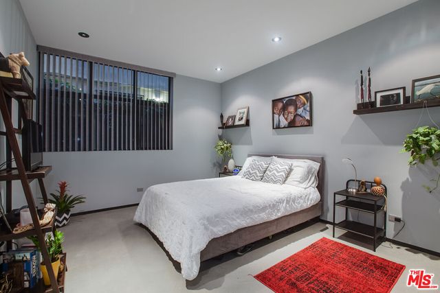 a bedroom with a bed furniture and a window