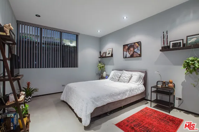 a bedroom with a bed furniture and a window