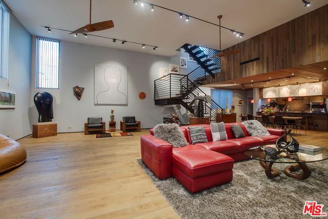 a living room with furniture gym equipment and a large window