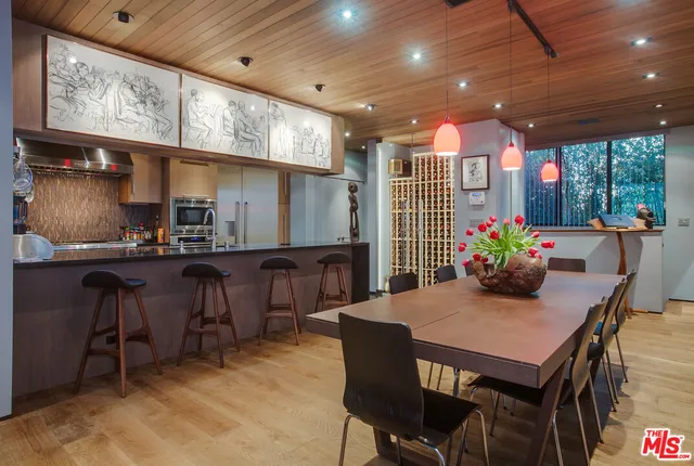 a dining room with furniture a window and kitchen view