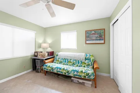 a dining room with wooden floor a glass table and chairs