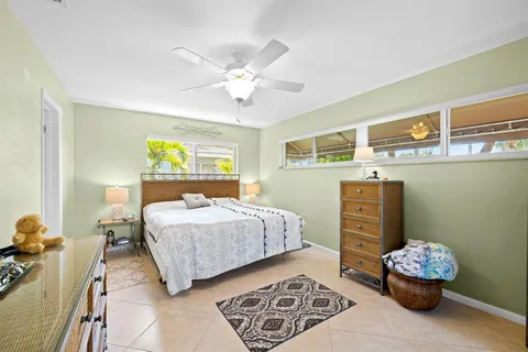 a bedroom with a bed and ceiling fan