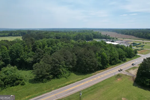 an aerial view of a city with lots of residential buildings and mountain view in back