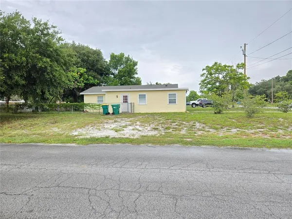 a view of house with outdoor space and swimming pool