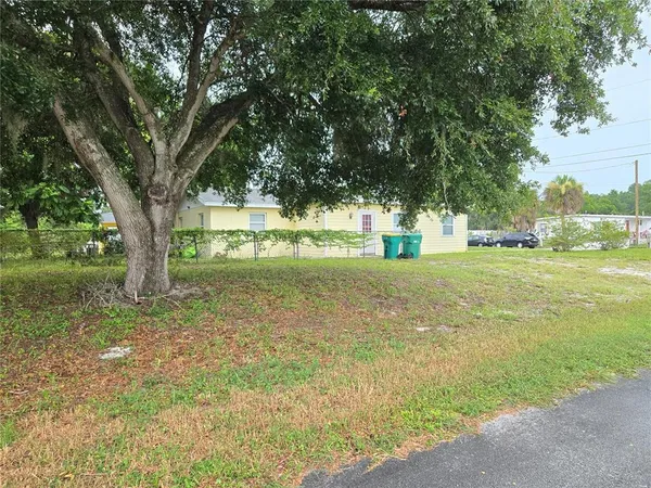 a view of lawn chairs and small yard