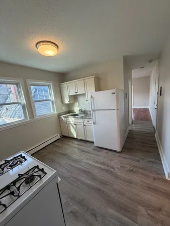 a kitchen with a stove and a refrigerator