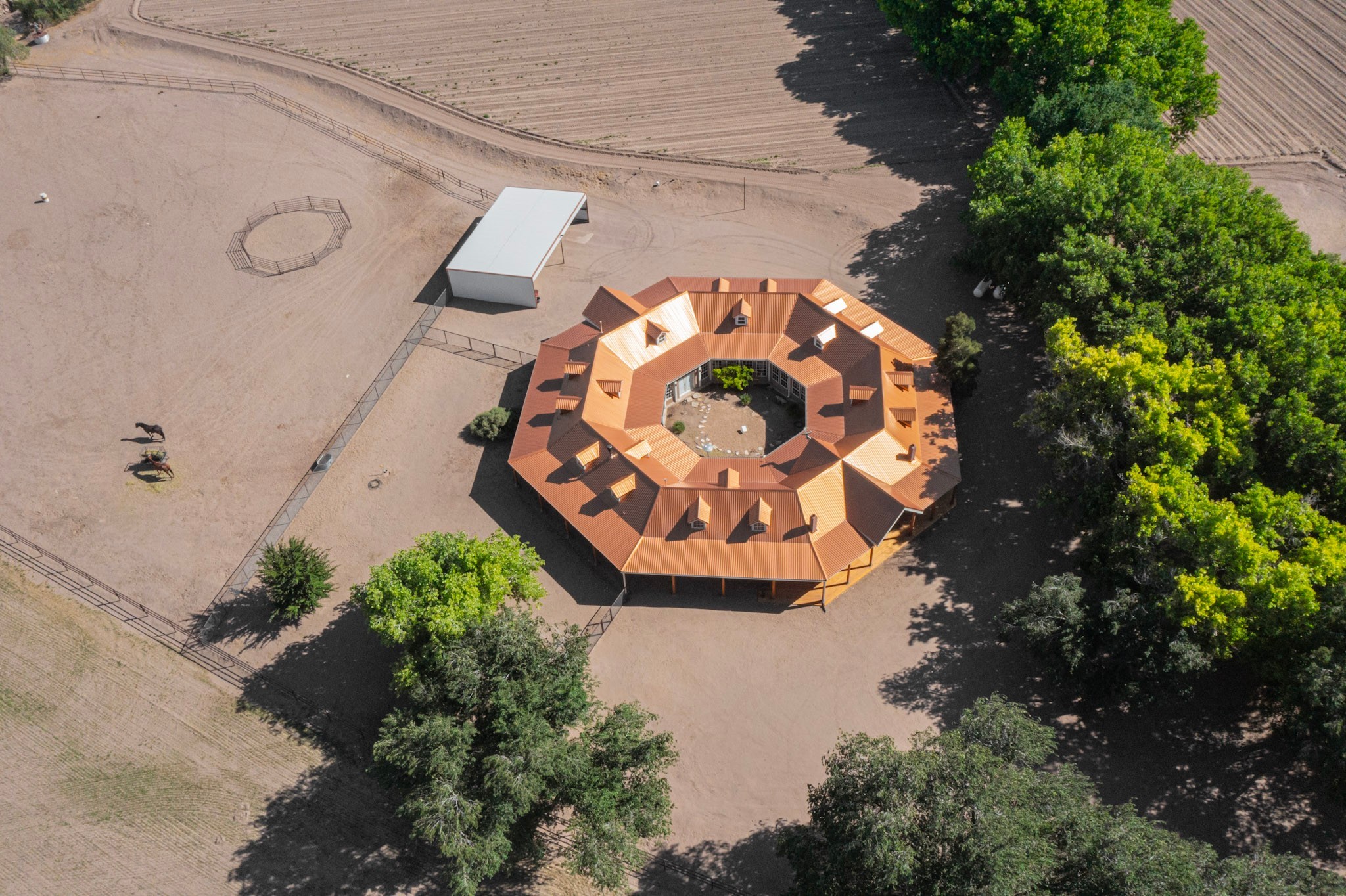 26 Schmittle Road Socorro, NM 87801 - Photo 7 of 80 Aerial of the fields by the house showing dry lot, carport and octagon shape of the home
