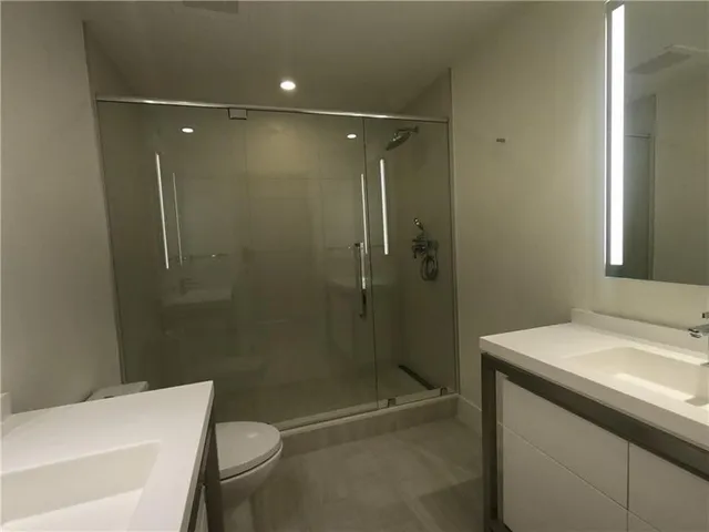 a bathroom with a toilet and shower