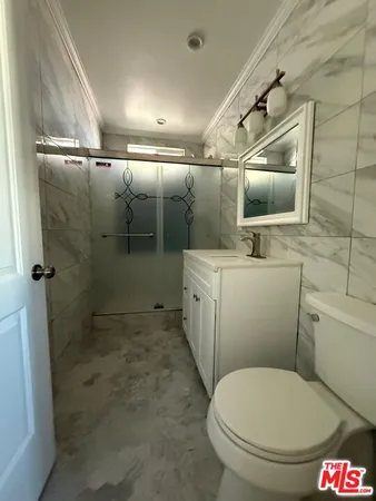 a bathroom with a toilet sink and shower