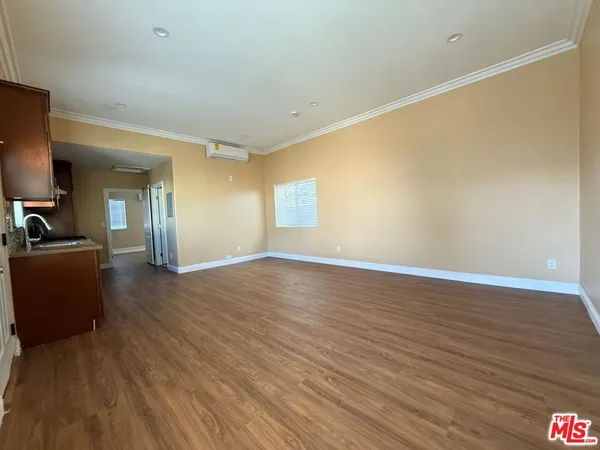 a view of a livingroom with wooden floor and furniture