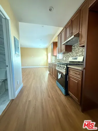 a kitchen with stainless steel appliances granite countertop a stove and a sink