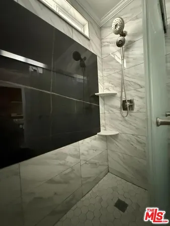 a bathroom with a shower and a mirror