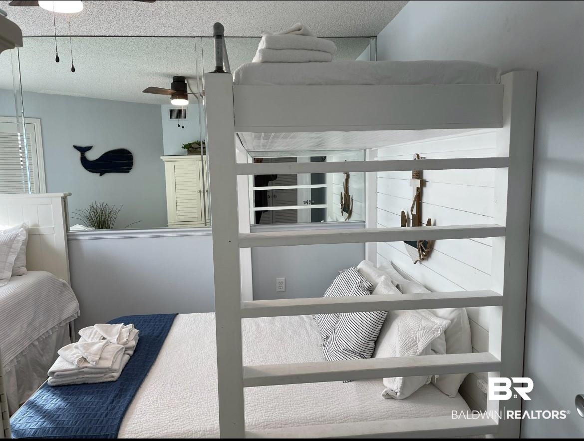 497 Plantation Road, Unit 1156 Gulf Shores, AL 36542 - Photo 16 of 28 Bedroom featuring a textured ceiling and visible vents