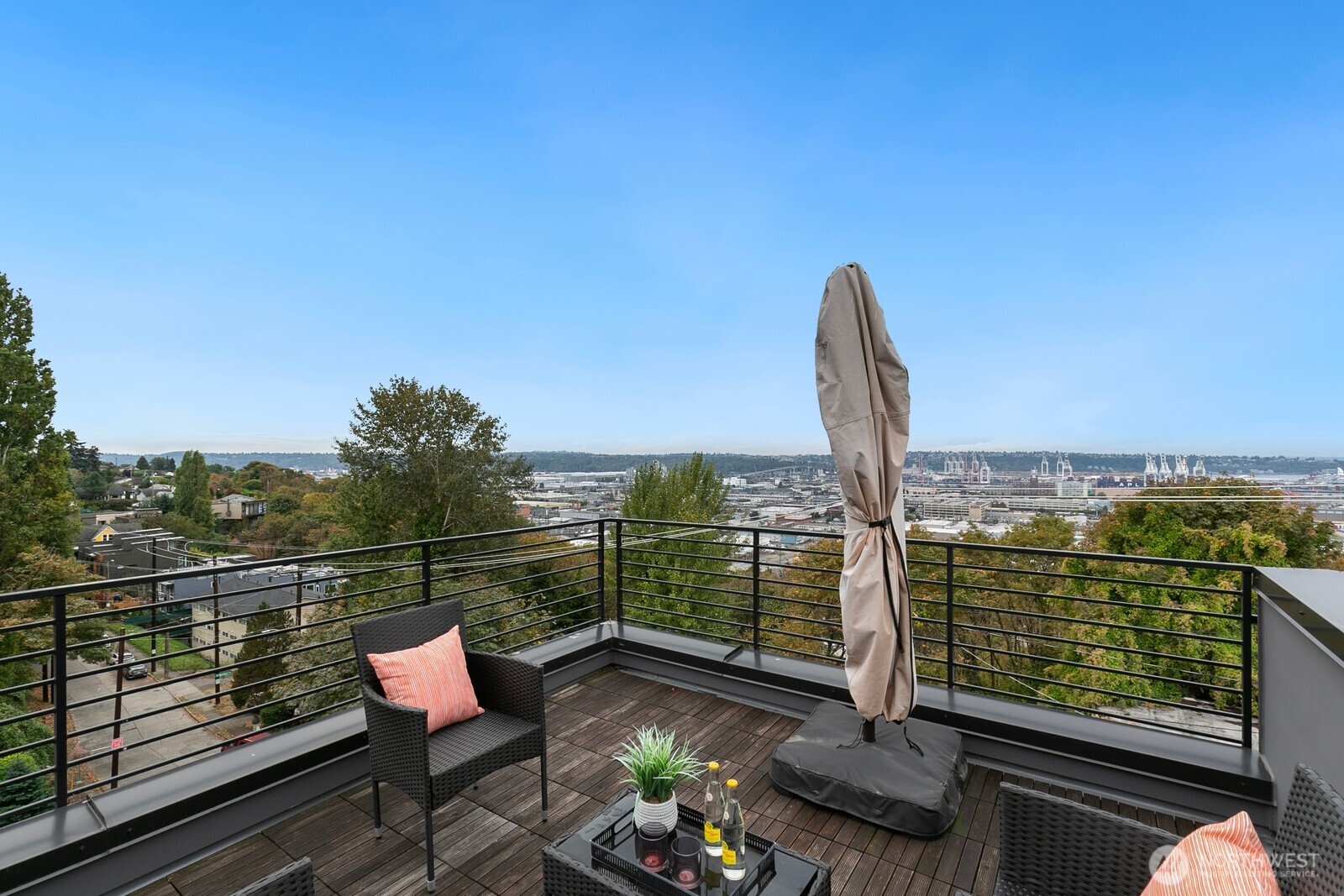 2408 13th Avenue South Seattle, WA 98144 - Photo 22 of 32 a view of a balcony with two chairs and a potted plant