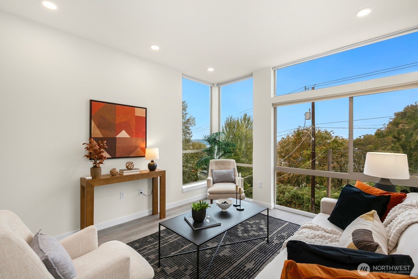 2408 13th Avenue South Seattle, WA 98144 - Photo 4 of 32 a living room with furniture a flat screen tv and a floor to ceiling window