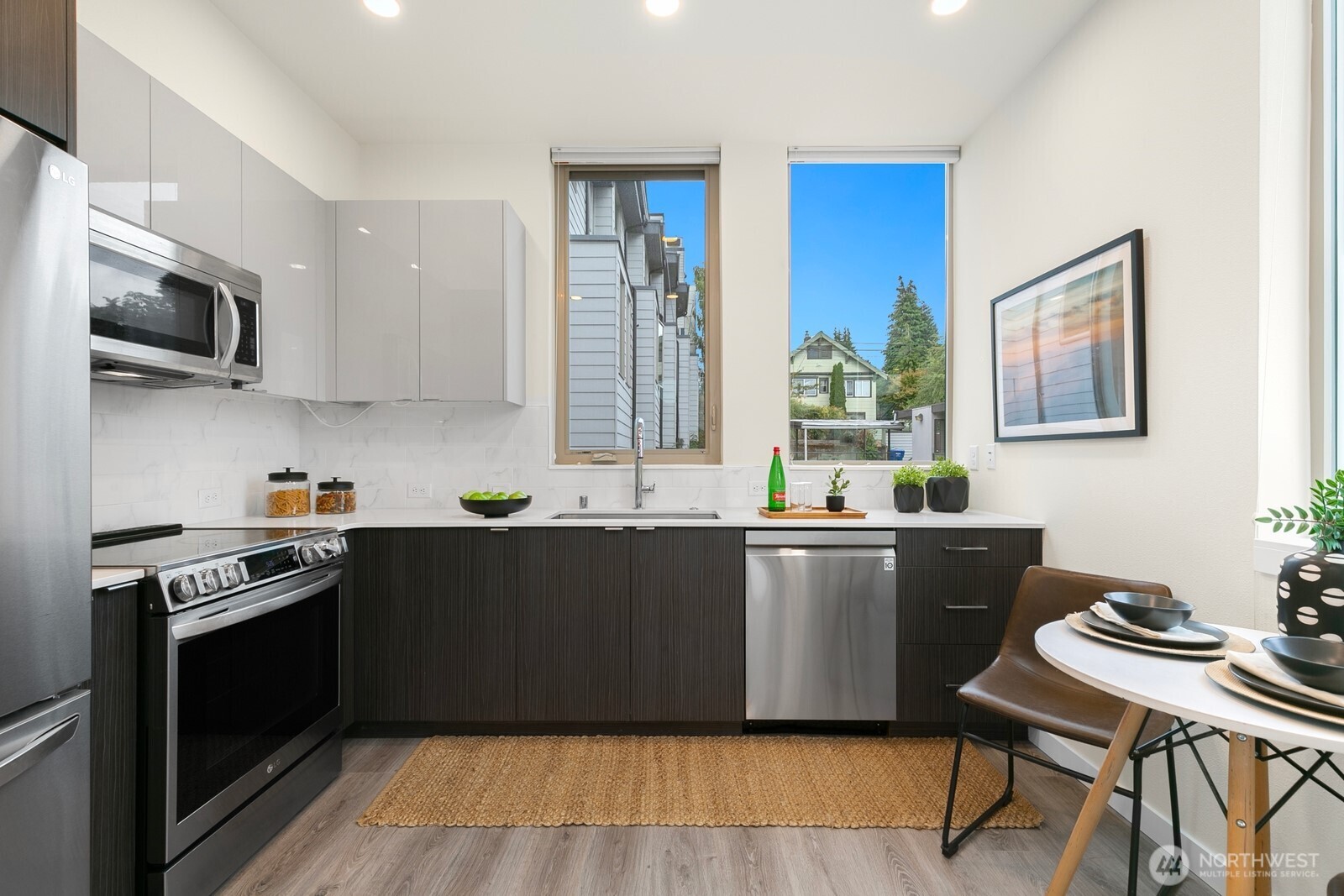 2408 13th Avenue South Seattle, WA 98144 - Photo 9 of 32 a kitchen with stainless steel appliances wooden floor and a sink