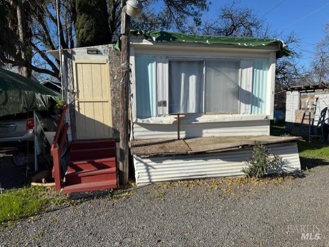 9415 Stevenson Bridge Road Winters, CA 95694 - Photo 14 of 15 a view of a house with a small yard and large tree