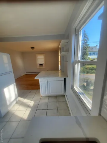 a kitchen with stainless steel appliances granite countertop a sink and a refrigerator