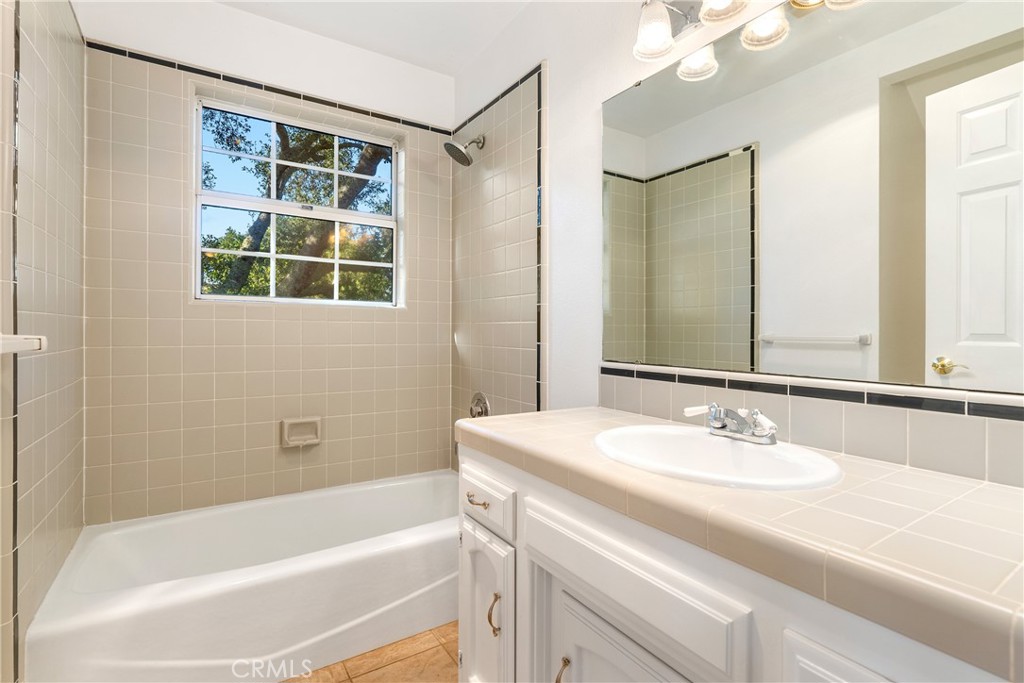 10885 San Marcos Road Atascadero, CA 93422 - Photo 23 of 35 a bathroom with a tub sink and mirror